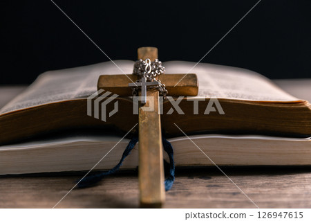 Religious belief concept Close up prayer Christian church service Bible Holy cross Spiritual power Blurred background Desk copy space Heaven God Catholic faith Praise book Jesus worship Gospel symbols 126947615