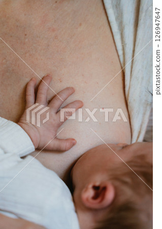 Mother Breastfeeding Newborn Baby with Care and Tenderness Mother Breastfeeding Newborn Baby with Care and Tenderness 126947647