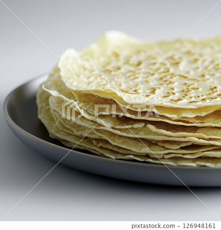 Freshly Made Thin Flatbreads Stacked on a Gray Plate with a Soft Background 126948161