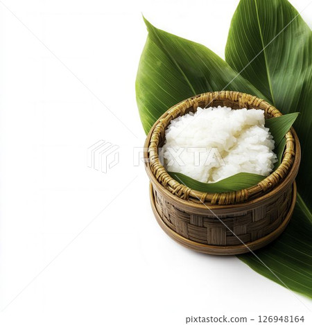 Freshly Steamed Rice in Bamboo Basket on Green Leaf Background in Natural Setting 126948164