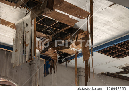 Ruin decay weathered old plywood ceiling collapse pull down, bad poor wood building roof structure 126948263