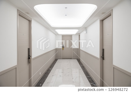 Hotel apartment hallway room door floor with modern lighting at ceiling with fire safety sprinkler 126948272