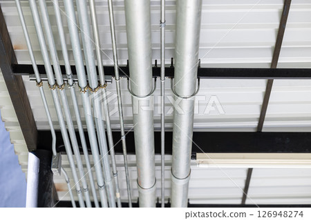 Conduit metal power pipe, Conduits Electrical power line system pipeline installed at ceiling. 126948274