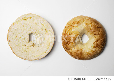Closeup view of slice of bagel breads isolated over white background. Top and middle part. Top view Closeup view of slice of bagel breads isolated over white background. Top and middle part. Top view 126948549