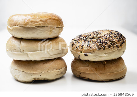 Closeup view of stack collection of bagel breads with various kind isolated over white background 126948569