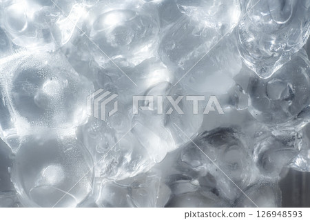 Closeup view of transparent glass with ice cubes. Drink and refreshment concept 126948593