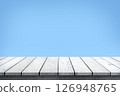 Empty white wooden table top on blue background, used for display or montage your products. 126948765
