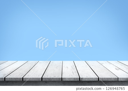Empty white wooden table top on blue background, used for display or montage your products. 126948765