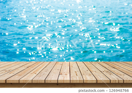 Empty wooden table top with blue sea summe background, used for display or montage your products. Empty wooden table top with blue sea summe background, used for display or montage your products. 126948766