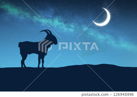 Silhouette of a goat on the field with a crescent moon on a night background. Eid al Adha concept 126948996