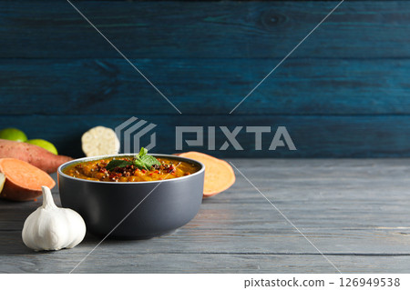 Sweet potato puree in bowl and ingredients on wooden background, space for text Sweet potato puree in bowl and ingredients on wooden background, space for text 126949538
