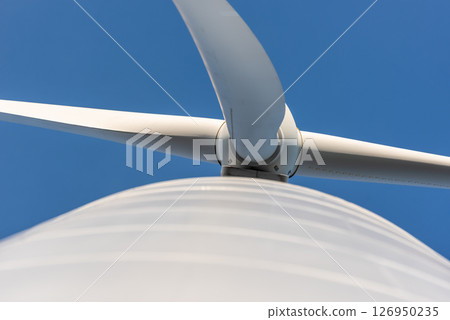 Modern wind turbine low angle view, directly below, against the blue sky 126950235