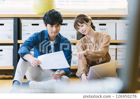 Man and woman sitting on the office floor 126950276