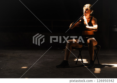 Muay thai, strong women fighter wrapped fist to Bare Knuckle fighting Asian kick boxing style people Muay thai, strong women fighter wrapped fist to Bare Knuckle fighting Asian kick boxing style people 126950342