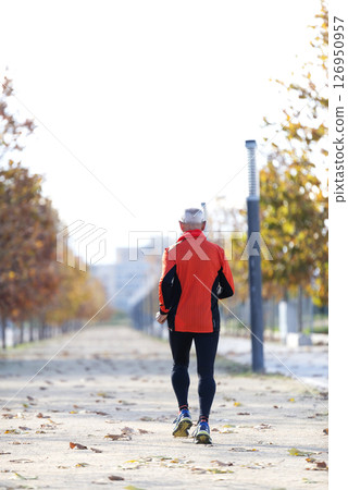 Senior man jogging in the park on a sunny day 126950957