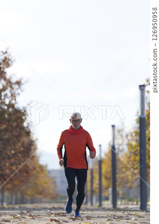 Senior man running outdoors in sportswear 126950958