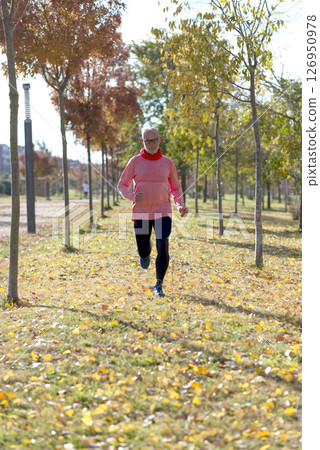 Senior man running outdoors in sportswear 126950978