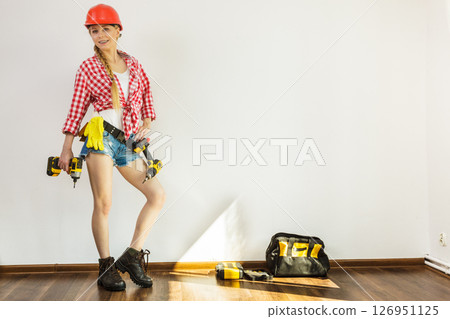 Girl using some power tools for work at home 126951125