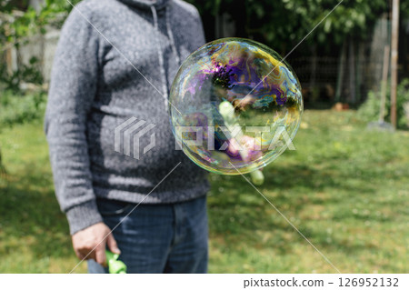 Soap bubble, outdoors activity and leisure for happy kid, real life photo 126952132
