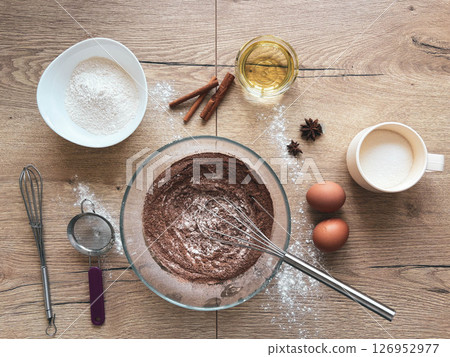 Ingredients for baking dough or cake. White sugar, butter, flour, eggs and spices with kitchen utensils on wooden table, Top view. Ingredients for baking dough or cake. White sugar, butter, flour, eggs and spices with kitchen utensils on wooden table, Top view. 126952977