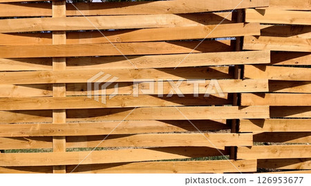 wooden fence in rural setting on sunny day, highlighting craftsmanship and natural beauty. closeup. 126953677