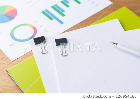Paperclip with documents, graphs and files 126954165