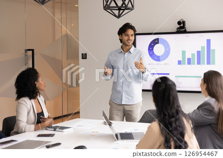 Young male professional presenting data to teammates 126954467