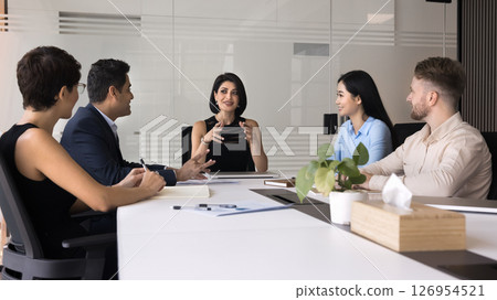 Attractive businesswoman and teammates collaborating on presentation 126954521