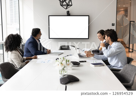 Group of four business professionals engaged in videocall Group of four business professionals engaged in videocall 126954529