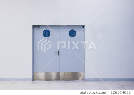 A pair of distinctive doors featuring blue circular designs on them A pair of distinctive doors featuring blue circular designs on them 126954632