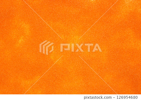 Here is a detailed close up image featuring a piece of bright orange glitter Here is a detailed close up image featuring a piece of bright orange glitter 126954680