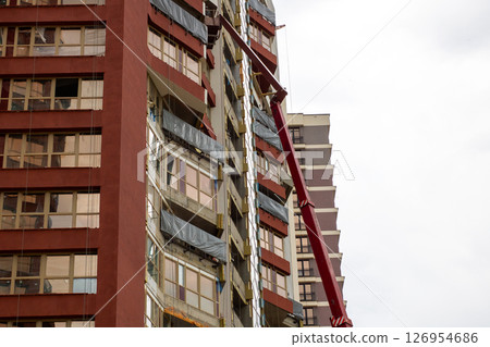 There is a very tall building standing with a ladder attached to its side There is a very tall building standing with a ladder attached to its side 126954686