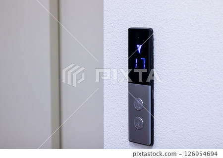 An elevator control panel featuring the number 17 prominently displayed on it 126954694