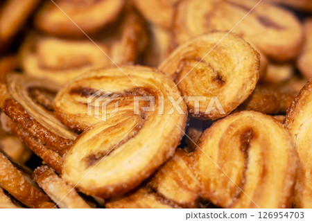 This is a close up image showcasing a delightful pile of heart shaped cookies This is a close up image showcasing a delightful pile of heart shaped cookies 126954703