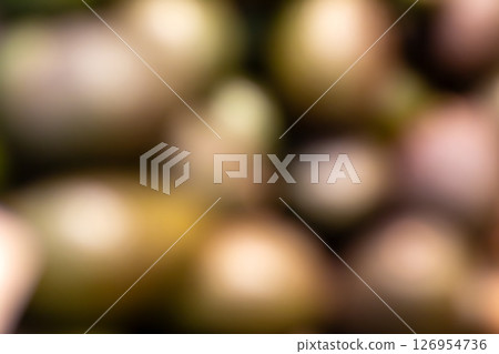 A blurry picture of a collection of eggs arranged on a table 126954736