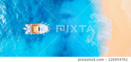 Drone view of the motor boat. Marine transport. Beach and waves. Vacation and holidays.  126954761