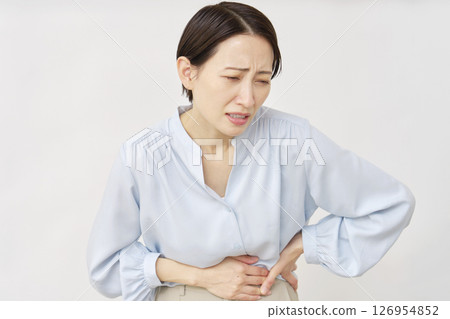 Woman in her 40s, abdominal pain, white background Woman in her 40s, abdominal pain, white background 126954852