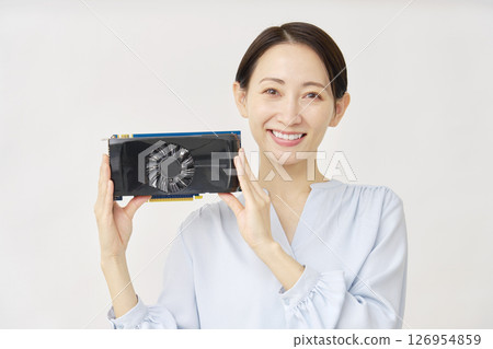 A woman in her 40s holding a graphics board on a white background A woman in her 40s holding a graphics board on a white background 126954859