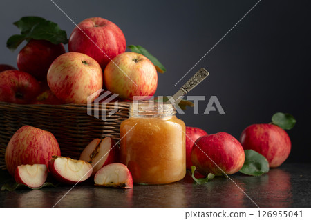 Apple jam and fresh apples on a black stone table. 126955041