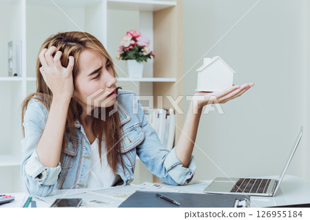 Young women teen working at business office desk stress thinking about debt house loan, home refinancing concept Young women teen working at business office desk stress thinking about debt house loan, home refinancing concept 126955184