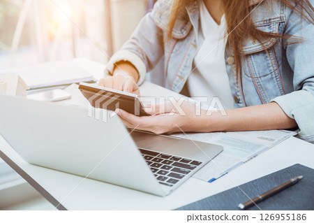 closeup business people using calculator, risk management, accountant cost expense income calculate future investment concept closeup business people using calculator, risk management, accountant cost expense income calculate future investment concept 126955186