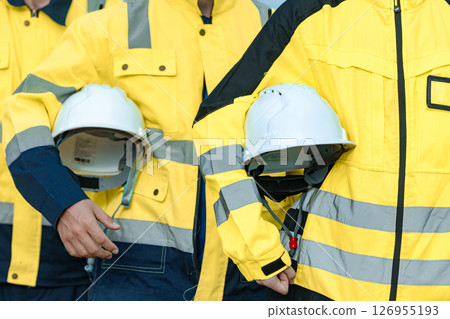closeup safety equipment hardhat, engineer worker specialist expert team. professional skill worker standing confident 126955193