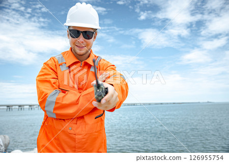 Portrait professional happy smiling Petroleum worker male with natural gas pipe reach to ocean Portrait professional happy smiling Petroleum worker male with natural gas pipe reach to ocean 126955754