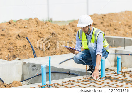 Asian construction engineer, Japanese builder worker male working inspecting footing house building. 126955816