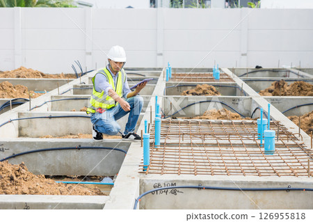 Asian construction engineer, Japanese builder worker male working inspecting footing house building. 126955818