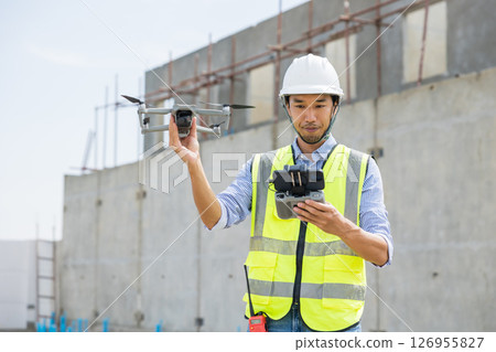 Professional construction engineer builder using UAV Drone to help assist construction site inspect Professional construction engineer builder using UAV Drone to help assist construction site inspect 126955827
