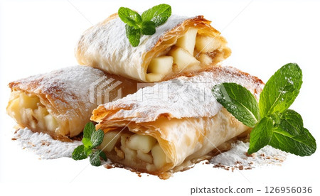 Warm apple strudel topped with a sprinkle of sugar and mint leaves 126956036