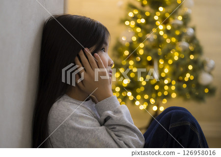A room with a Christmas tree 126958016