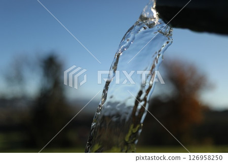 Stream of water is flowing from a pipe 126958250