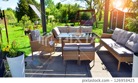 Modern aluminum pergola with stylish garden furniture in a beautiful garden. 126958425